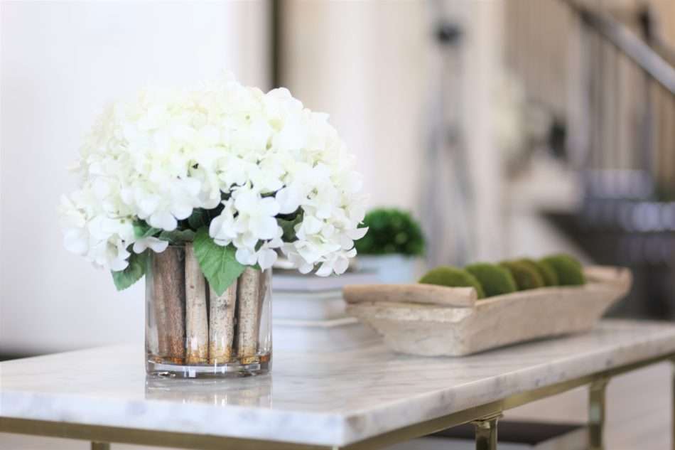 living room decor, living room colors, blue living room, gray sofa, bar stools at island. ivory kitchen, summer decor, blue summer decor, summer living room, colorful living room, coffee table, marble coffee table, coffee table decor, hydrangeas, blue vases, built ins, living room built ins, display box, living room pillows, blue pillows, navy pillows