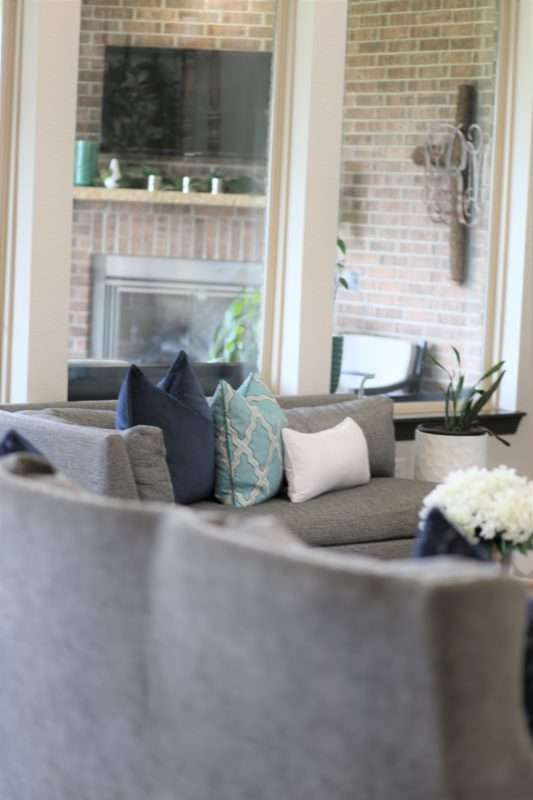 living room decor, living room colors, blue living room, gray sofa, bar stools at island. ivory kitchen, summer decor, blue summer decor, summer living room, colorful living room, coffee table, marble coffee table, coffee table decor, hydrangeas, blue vases, built ins, living room built ins, display box, living room pillows, blue pillows, navy pillows