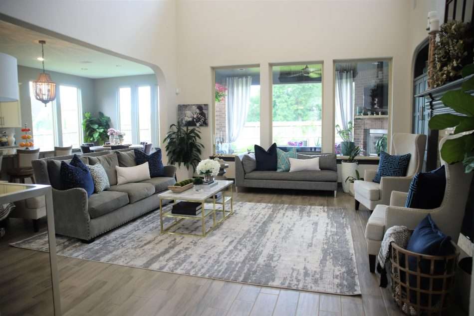 living room decor, living room colors, blue living room, gray sofa, bar stools at island. ivory kitchen, summer decor, blue summer decor, summer living room, colorful living room, coffee table, marble coffee table, coffee table decor, hydrangeas, blue vases, built ins, living room built ins, display box, living room pillows, blue pillows, navy pillows