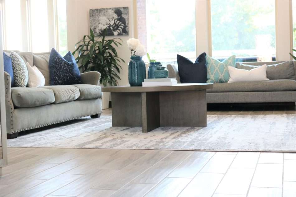 blue accessories, blue decor, living room with blue decor, gray sofa, living room decor, living room, neutral living room, pops of blue, blue colors in living room, blue pillows, blue vases, wooden coffee table